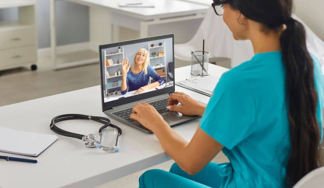Healthcare professional attending a virtual consultation with a patient.
